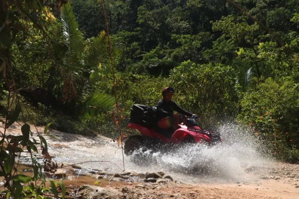 Tourist on ATV exploring the stunning landscapes, travel to Puerto Vallarta for an exciting adventure in the jungle and mountains.